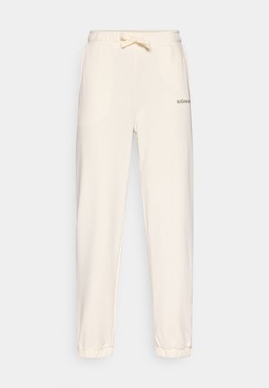 Béžové tepláky z měkké tkaniny, s elastickým pasem se šňůrkou a žebrovanými manžetami; černé logo "BJÖRN" na boku.