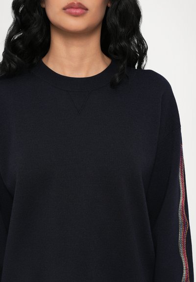 Navy blue sweater made of a textured knit material. Features a crew neck and colorful striped accents on the sleeves.