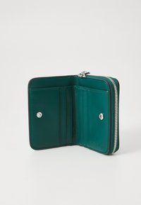 Zippered wallet in dark teal leather with six card slots, a snap button closure, and silver hardware accents. Smooth texture, minimal design.