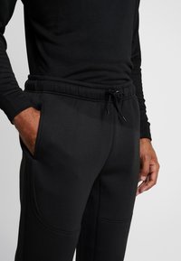 Urban Classics CUT AND SEW PANTS - Jogginghose - black