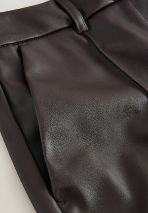 Dark brown leather trousers with a smooth texture, featuring pleats at the front and a waistband with a stitched detail.
