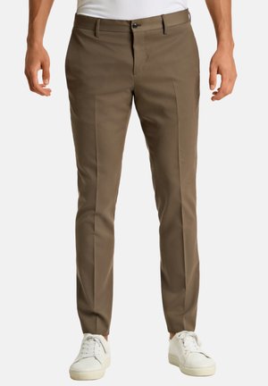 Brown tailored trousers made of smooth fabric, featuring a flat front, straight legs, and a single button closure. Worn with white sneakers.