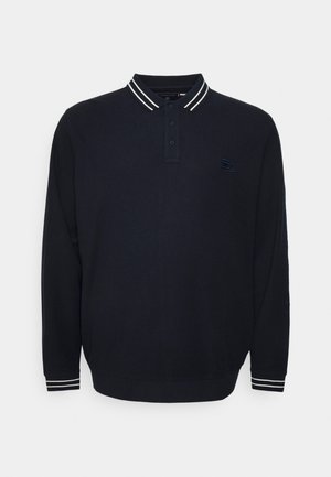 Polo à manches longues bleu marine avec double rayures blanches sur le col et les poignets, patte de boutonnage à trois boutons, et petit logo sur la poitrine gauche.