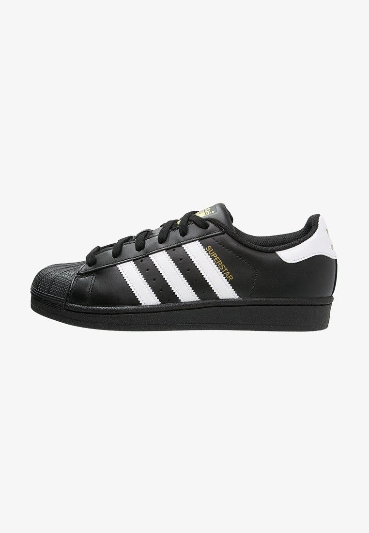 Black leather sneakers with white three-stripe design, rubber shell toe, black laces, and gold accents. Smooth texture with perforated details.