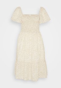 Robe beige à imprimé floral avec un décolleté carré, des manches bouffantes et un ourlet à volants. Confectionnée dans un tissu léger avec des détails froncés au niveau du corsage.