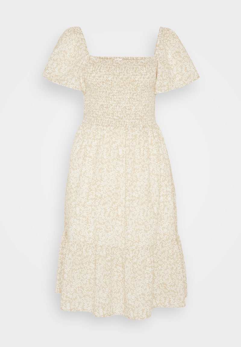 Robe beige à imprimé floral avec un décolleté carré, des manches bouffantes et un ourlet à volants. Confectionnée dans un tissu léger avec des détails froncés au niveau du corsage.