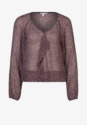 Blouse transparente à manches longues avec un col en V. Présente un devant à volants et un motif léopard dans des nuances de rose et de bleu foncé.