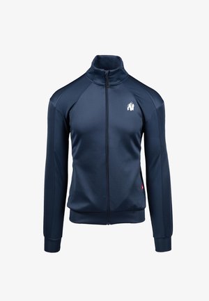 Marineblaue Sportjacke mit hohem Kragen und vollem Reißverschluss. Mit strukturierten Seitenpaneelen und einem Logo auf der oberen linken Seite. Glatte Stoffoberfläche.