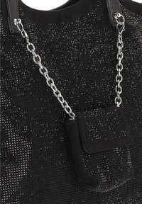 Bolso tote negro con un exterior texturizado, que cuenta con un detalle de cadena plateada y una pequeña bolsa adjunta. Asas lisas completan el diseño.