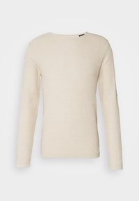 Pull à manches longues et col rond en tissu tricoté texturé beige clair avec un motif côtelé, sans boutons ni ornements visibles.