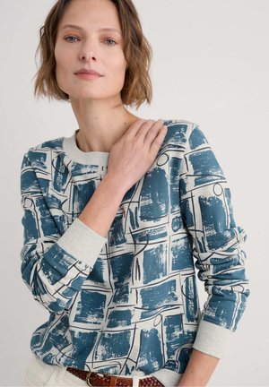 Blauwe en crèmekleurige sweatshirt met patronen, lange mouwen, ronde halslijn en contrasterende ribboorden; bevat een abstract ontwerp met penseelstreken.