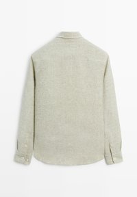 Light beige long-sleeve button-up shirt with subtle vertical stripes shown from the back on a plain white background.