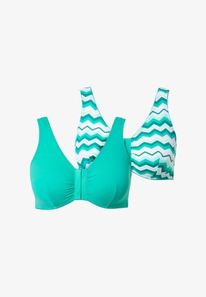 Zwei kabellose BHs, einer in festem Türkis mit Vorderverschluss, einer mit türkisem und weißem Zickzackmuster, vor weißem Hintergrund dargestellt.