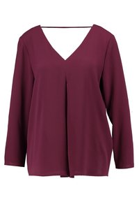 Blusa bordeaux con scollatura a V, maniche lunghe e vestibilità rilassata. Realizzata in tessuto leggero con una geometria sottile e un drappeggio elegante.