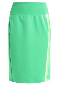 Green stretchy skirt with a ribbed waistband, featuring side pockets and a contrasting white and light green vertical stripe design.