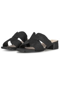 Sandales glissantes noires en tissé avec un talon plat, présentant un design entrecroisé sur le dessus et une finition texturée.