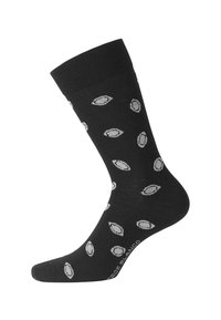 Chaussettes noires en coton avec un poignet côtelé, comportant un motif répété de formes ovales gris clair. Du texte le long du bord inférieur affiche le nom de la marque.