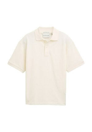 Korte mouwen polo shirt in licht crèmekleurig, gemaakt van katoen. Beschikt over een klassieke kraag en een knoopsluiting met drie knopen. Soepele textuur, relaxte pasvorm.