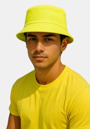 Yellow bucket hat made of fabric with a wide brim; paired with a matching yellow t-shirt. Simple design with smooth texture.