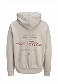 Beež puuvillane kapuutsiga dressipluus, millel on kapuuts, soonikkoes varrukasäärised ning pruuniga trükitud tekst seljal, mis annab teavet brändi ja materjali kohta.