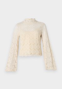 Top in pizzo color crema, con maniche a campana e collo alto. Motivo a diamante su tutta la superficie con dettagli a scallop sul fondo. Tessuto trasparente.