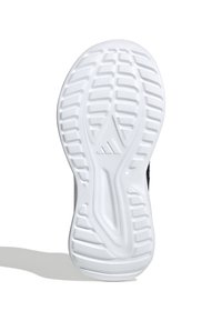 Semelle de chaussure en caoutchouc blanc avec des motifs de grip texturés, comportant une arche centrale et un logo. Le design est épuré avec un bord arrondi.