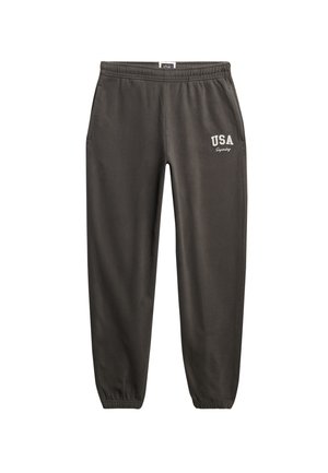 Pantalon de survêtement gris foncé avec taille et poignets élastiques, poches latérales et logo blanc « USA Superdry » sur la cuisse droite.