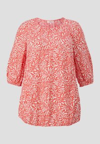 Blouse rouge et blanche avec un motif floral, présentant un col rond et de courtes manches bouffantes. Tissu doux et léger. Ourlet élastique.