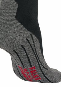 Calze nere e grigie con lavorazione a maglia testurizzata. Presentano un marchio rosso, tallone rinforzato e linee di grip lungo il piede per una maggiore stabilità.