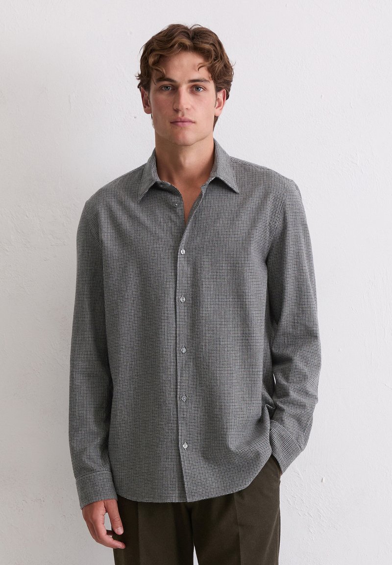 Langärmliges Button-Up-Hemd in einem schwarz-weißen Karomuster, mit klassischem Kragen, weichem Stoff und glatten Knöpfen.