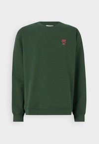 Dark green cotton sweatshirt with long sleeves, ribbed cuffs, and a round neck. Features a small red embroidered design on the chest.