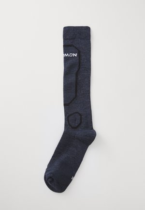 Navy blue knee-high sock with black outline patterns and white text partially visible on plain white background.