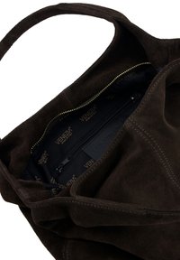 Brown suede tote bag with a soft texture, featuring a zippered inner pocket and a gold zipper on a dark fabric lining.