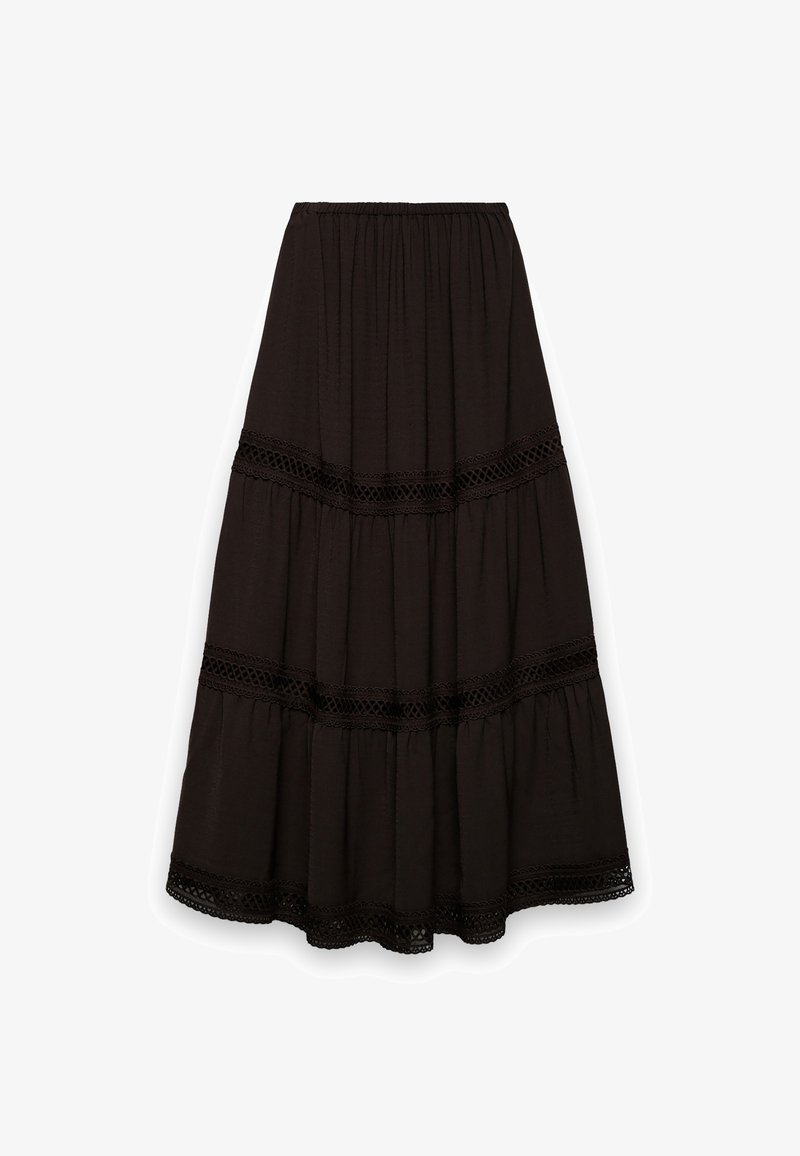 Jupe longue noire à volants superposés. Confectionnée dans un tissu doux, avec des accents de bordure en dentelle le long des coutures. Taille élastique pour un port facile.