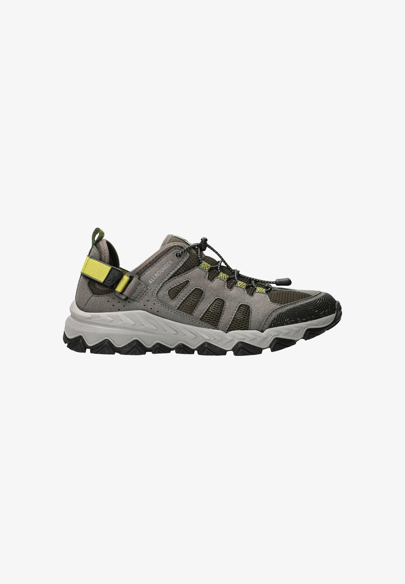 Gray and black outdoor sneaker with yellow strap, mesh panels, and thick rugged sole, designed for hiking or active wear.