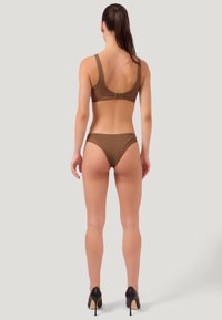 Bralette marron sans coutures et bas de bikini assortis avec une texture lisse, présentant de larges bretelles et un design au dos dégagé.