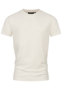 Camiseta de color beige claro hecha de algodón, con un cuello redondo, mangas cortas y una textura suave con un corte regular.