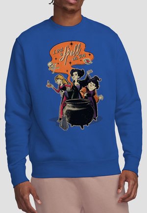 Blue sweatshirt featuring a witch-themed graphic with three witches around a cauldron, and text "I put a spell on you" in orange.