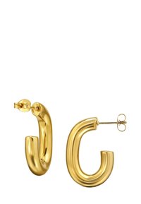 Boucles d'oreilles créoles dorées avec un design lisse et courbé. Dotées d'une surface brillante, fermeture par clip et d'une forme originale en "C" pour un style distinctif.