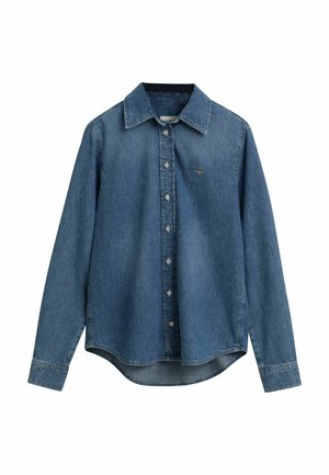 Denimhemd in middelblauw. Beschikt over een knoopsluiting aan de voorkant, kraag, lange mouwen en een licht afgeronde zoom. Subtiel logo op de borst.