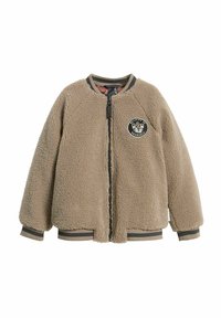 Tan fleecemössa med en rund applikation som har texten "Tro p�å dig själv", dragkedja, samt randiga ribbade ärmslut och nederkant. Mjuk, texturerad tissu.