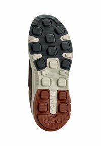 Schuhsohle mit schwarzen, cremefarbenen und roten Gummibereichen mit strukturierten Griffen; mehrere runde und quadratische Muster für Traktion.