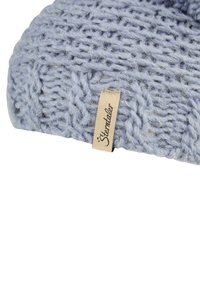 Knitted light blue beanie made of soft yarn, featuring a subtle braided pattern and a small label with the text "Sterntaler."