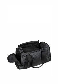 Black gym bag with a smooth nylon exterior, dual handles, and a zippered compartment. Features a logo on the side and spacious interior.