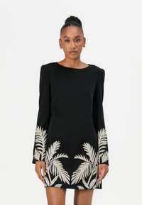 Black long-sleeve dress with a round neckline, featuring metallic silver palm leaf embroidery on the sleeves and lower hem. Smooth fabric texture.