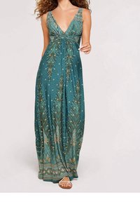 Robe longue à décolleté en V profond en teal avec des motifs botaniques dorés et une taille cintrée. Le matériau semble léger avec une silhouette fluide.