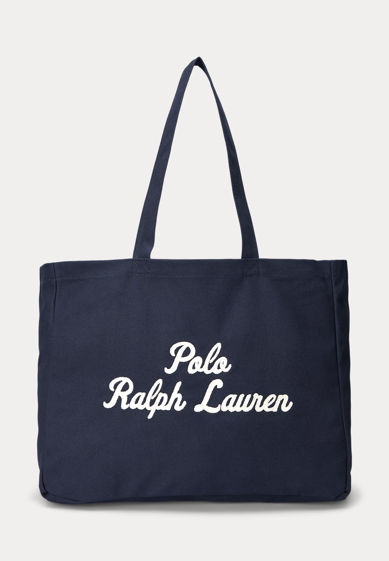 Tumesinine kandekott kahe õlarihma ja valge käsitsi kirjutatud tekstiga "Polo Ralph Lauren" ees keskel.