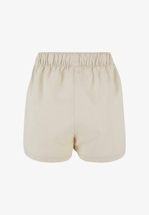 Beige korte broek met elastische tailleband en eenvoudig ontwerp, gemaakt van lichtgewicht stof, gezien van achteren.