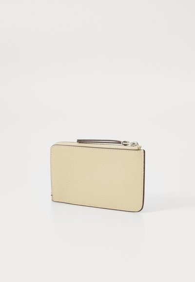 Pale yellow leather wallet with a textured finish, rectangular shape, top zip closure, and brown trim along the edges.