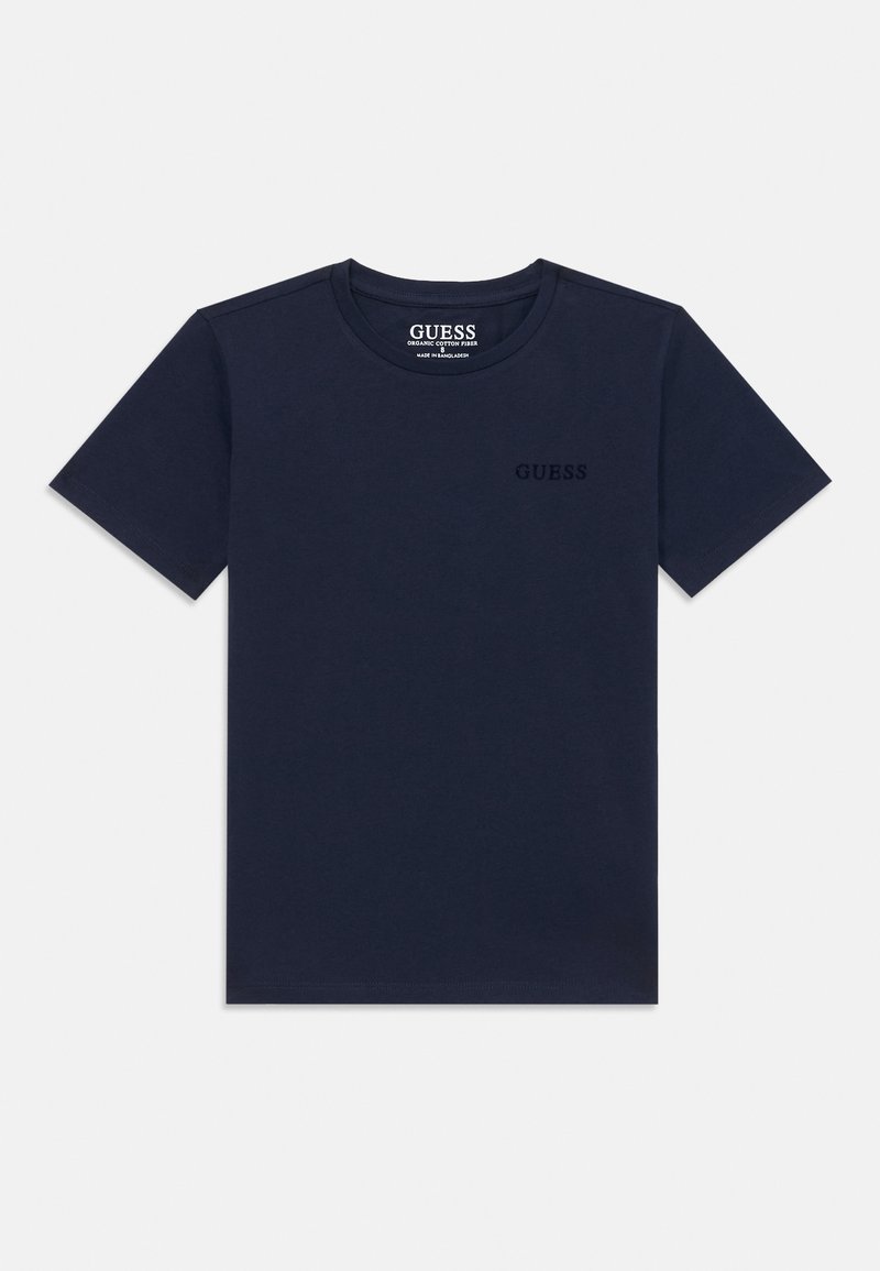 T-shirt en coton biologique bleu marine à manches courtes, col rond, avec un logo de marque subtilement en relief sur la poitrine gauche.